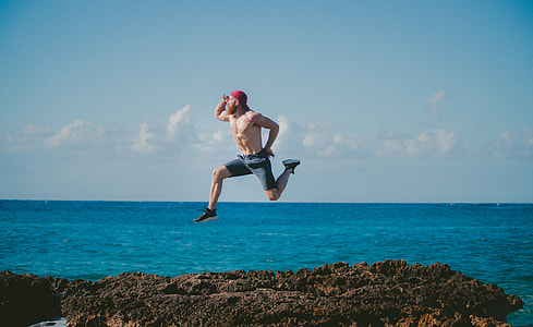 person floating on seashore during daytime thumbnail