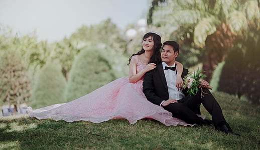 Nuptial Photo of Man in Black Formal Suit and Woman in Pink Gown thumbnail