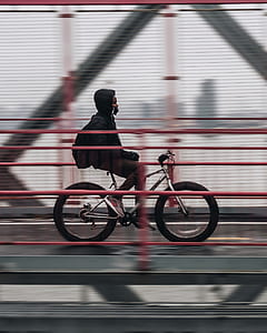 timelapse photography of man ride on bicycle thumbnail