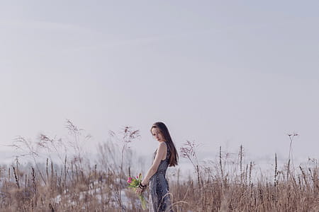 Woman Wearing Black and Grey Sleeveless Dress Standing on Field thumbnail