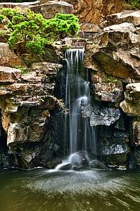 waterfalls surrounded by brown rocks thumbnail
