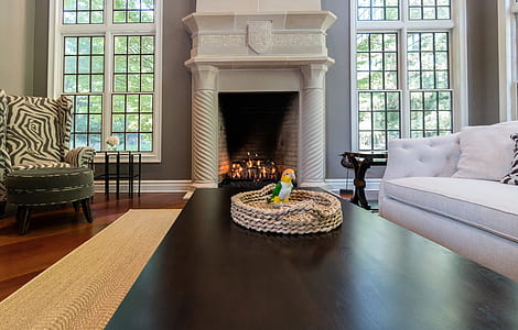 brown wooden coffee table beside fireplace thumbnail