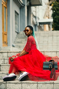 Woman Sitting on Stairway Wearing Sunglasses thumbnail