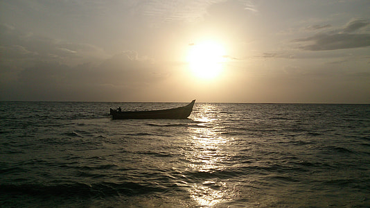 silhouette of canoe on sea at daytime thumbnail