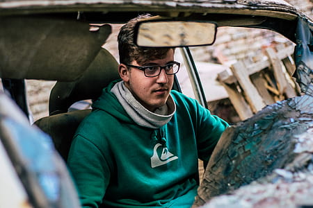 man riding on wrecked car thumbnail