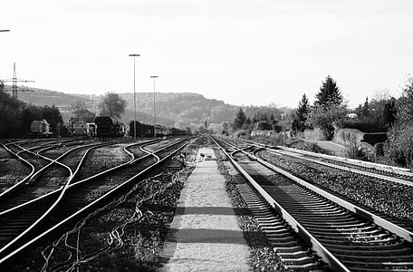 grayscale photography of train rail thumbnail
