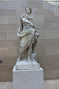 male statue against beige wall thumbnail