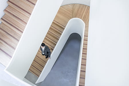 man standing on brown stairs thumbnail