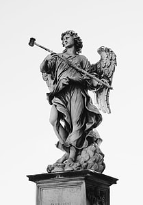 grayscale photo of person holding stick statue thumbnail