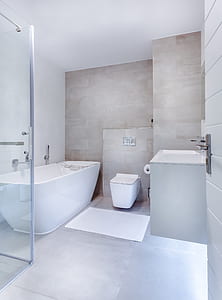 white ceramic bath tub near toiley thumbnail