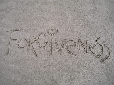 closeup photo of Forgiveness drawn in sand thumbnail