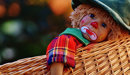 clown doll on brown wicker basket thumbnail
