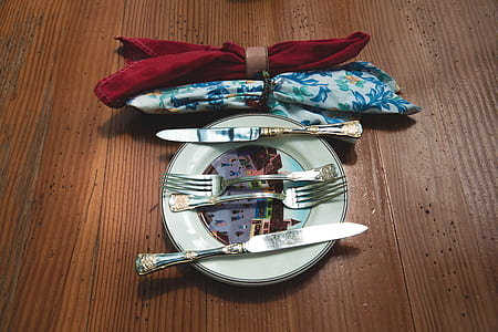 silver flatware set on ceramic plate thumbnail