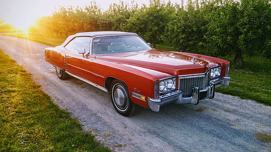 red coupe parked on sidewalk thumbnail