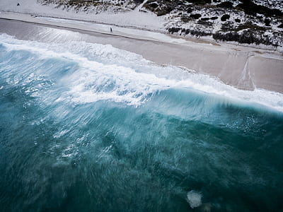 person standing near ocean water thumbnail