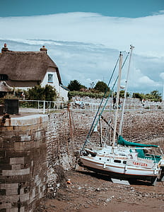 white Tantura boat near brown wall thumbnail
