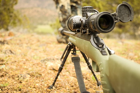shallow focus photo of rifle with scope thumbnail
