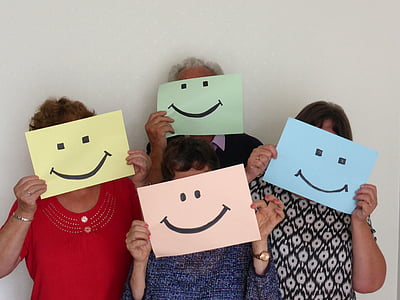 group of people holding smiley illustrations thumbnail