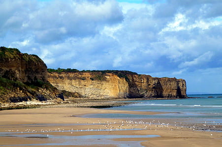 rock formation near body of water thumbnail