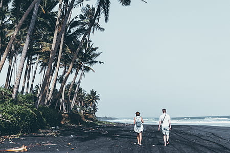 man and woman walking on the beach thumbnail