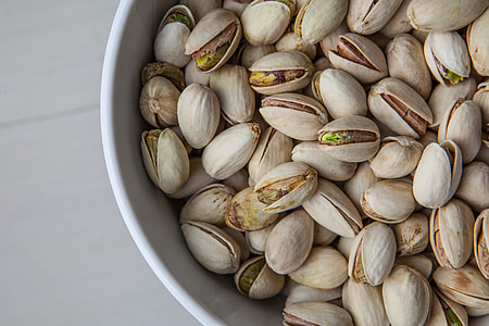 Close up shot of a bowl of pistachio nuts sitting on a wooden table, image captured with a Canon 5D thumbnail