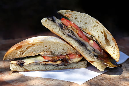 two burger with tomatoes and cheese on white paper thumbnail