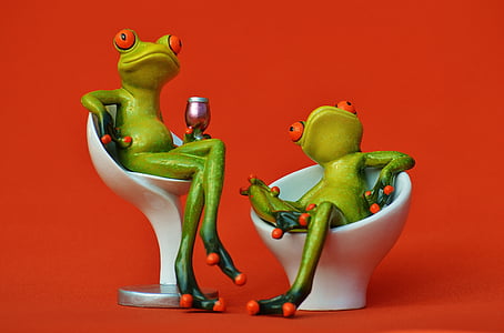 two green frogs sitting on white chairs thumbnail