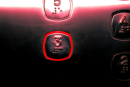 close-up photo of black and red 3 button thumbnail