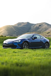 blue Toyota coupe in the grass thumbnail
