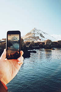 person taking Facebook live video of snowy mountain thumbnail