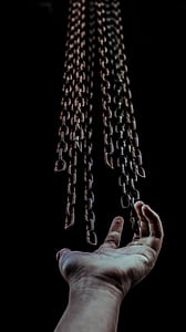 photography of person touching heavy chains thumbnail