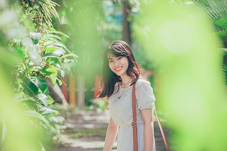 Woman Standing Nearby Green Leafed Plant thumbnail