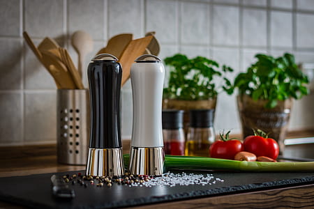 two white and black condiment shakers on black board thumbnail