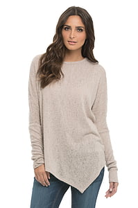 woman wearing gray asymmetrical sweater and blue denim bottoms thumbnail