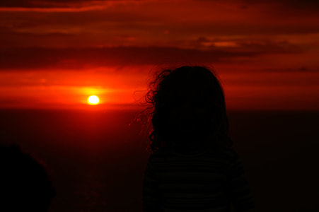 silhouette of person with red sunset in background thumbnail