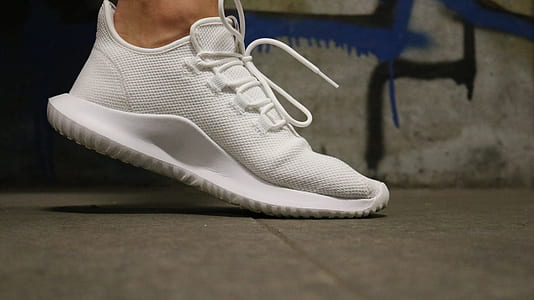 person wearing white Adidas Tubular shadow shoe thumbnail