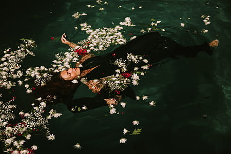 fashion photography of woman in black dress floating on water thumbnail