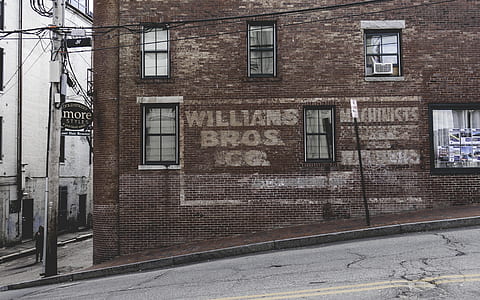 brown concrete building near road during daytime thumbnail
