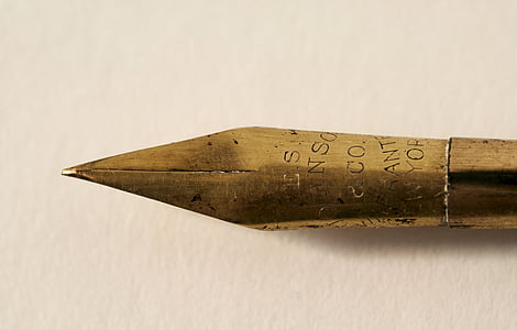 close-up photography of brass-colored pen thumbnail