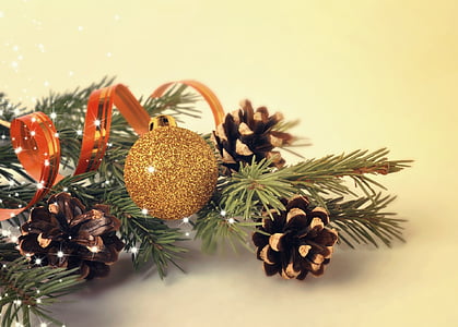 closeup photo of a gold bauble hanging on lit tree thumbnail