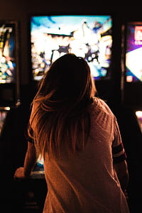 woman playing arcade machine thumbnail
