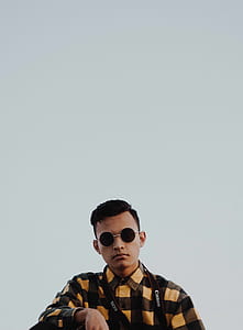 man wearing sunglasses with gold-colored frames while taking selfie thumbnail