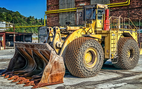 yellow front-loader outside the building thumbnail