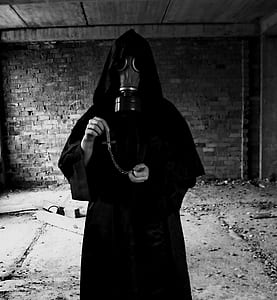 grayscale photo of person wearing black gas mask and robe thumbnail