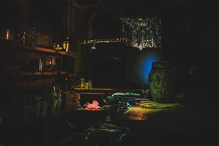green vase beside gloves on table thumbnail