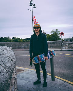 man holding skateboard thumbnail