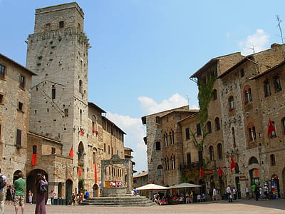 people standing beside concrete buildings thumbnail