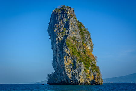 photo of green mountain island in body of water thumbnail