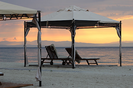 two sun loungers under white canopy near beach thumbnail