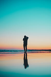 silhouette of person on the shore thumbnail